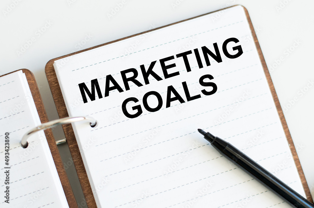 Marketing goals inscription on the notepad on the table next to the black marker Marketing goals inscription on the notepad on the table next to the black marker