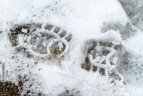 Single crisp boot print in thin white snow © Serjedi