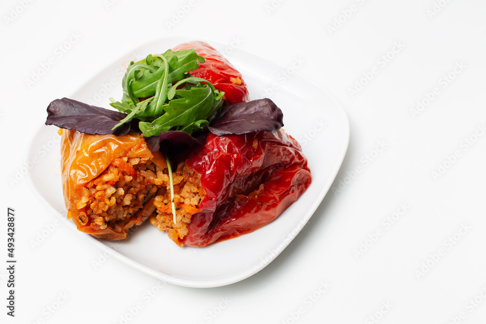 Homemade vegan food. Stuffed peppers with rice, mushrooms, served with rucola. Homemade vegan food. Stuffed peppers with rice, mushrooms, served with rucola.