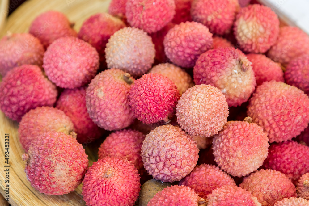 Container of fresh litchi or lychee fruit
