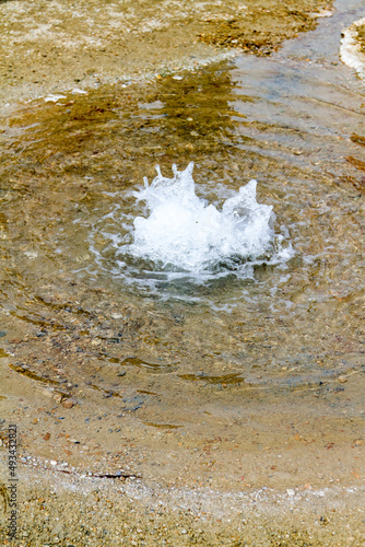 Splash produced in middle of pond with clear water © Serjedi