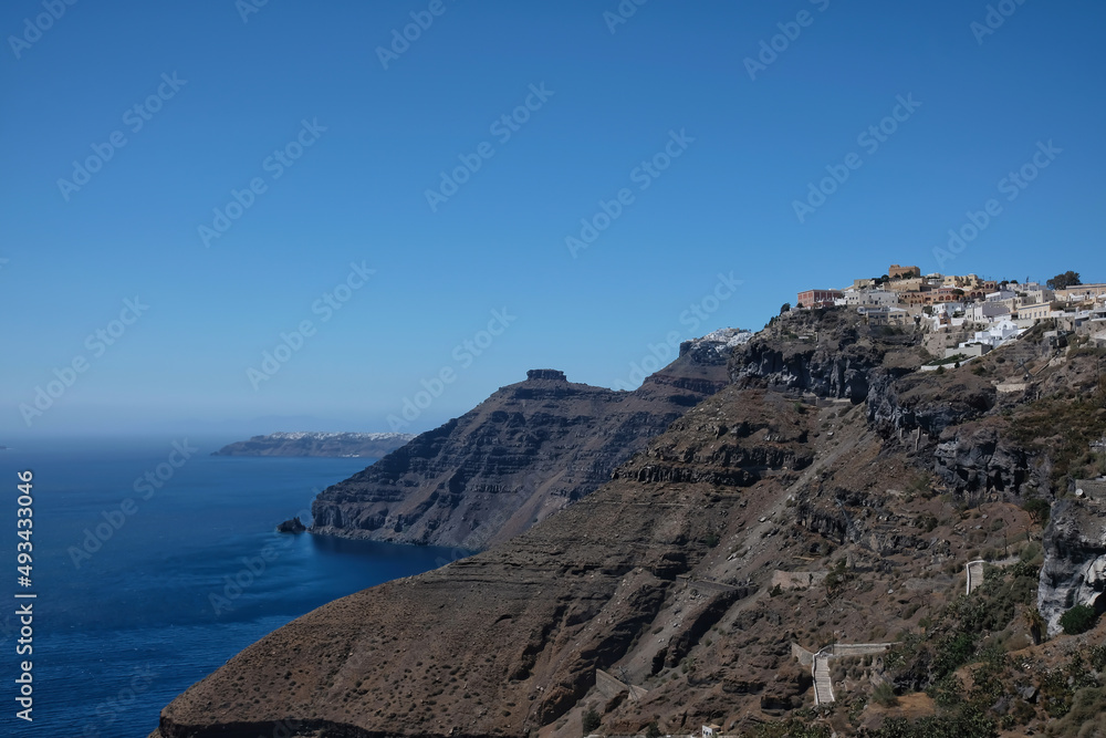 View of Fira and the picturesque village of Oia in the background in Santorini Greece