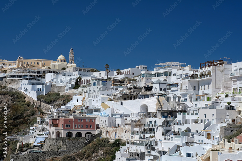 Panoramic view of the picturesque village of Fira Santorini with its hotels and restaurants on a beautiful and sunny day