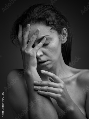 dramatic emotional portrait of a young girl with dark hair.grief emotion
