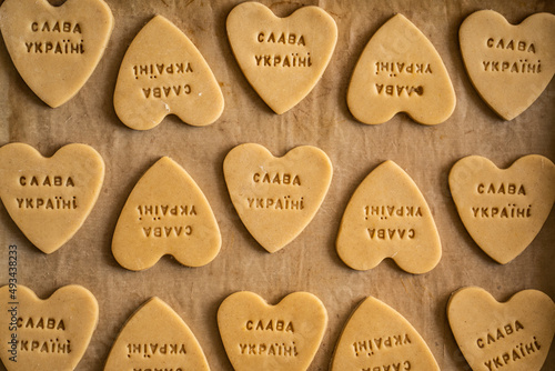 Heart shaped cookie mosaic.Made by volunteers. inscription Glory to Ukraine