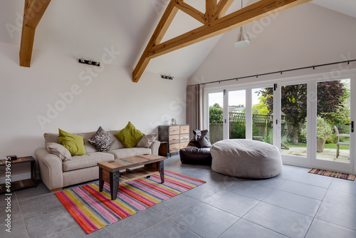 Modern furnished sitting room with bifold patio doors