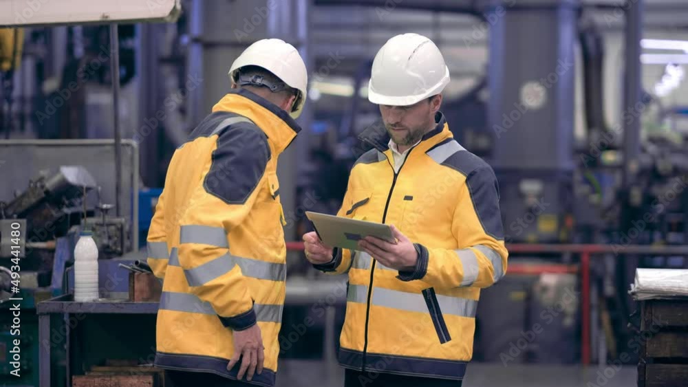 Two engineers at an industrial plant. Two workers control the work at the factory. Manufacture of cutting tools. Drill manufacturing plant. Two engineers at an industrial plant. Two workers control the work at the factory. Manufacture of cutting tools. Drill manufacturing plant.