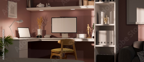 Trendy feminine home workspace or office desk interior with computer and laptop desktop