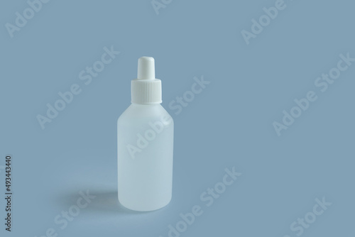  white medicine bottle on blue background