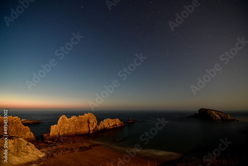 night sky over arnia playa beach, pielagos santander spain photo