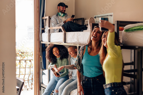 backpackers lifestyle in youth hostel - young people in room with bunk bed - travelers - students in the college dormitory photo