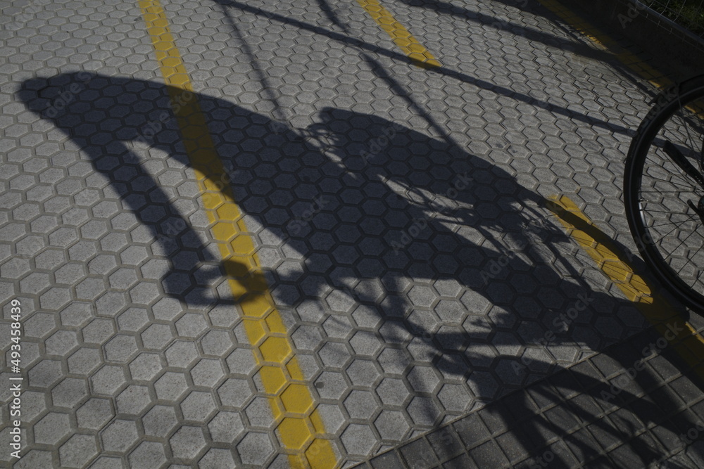 Shadow of a biker on the ground
