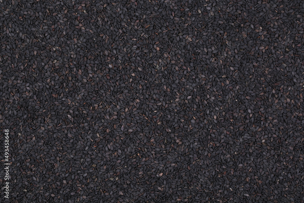 Background image of black sesame seeds. An ingredient for cooking. Ayurveda treatment. Alternative medicine. Background image of black sesame seeds. An ingredient for cooking. Ayurveda treatment. Alternative medicine.