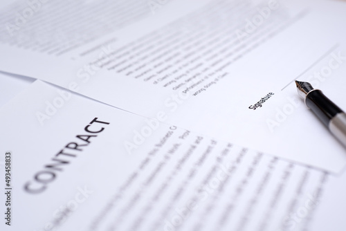 Close up of hand writing on contract 