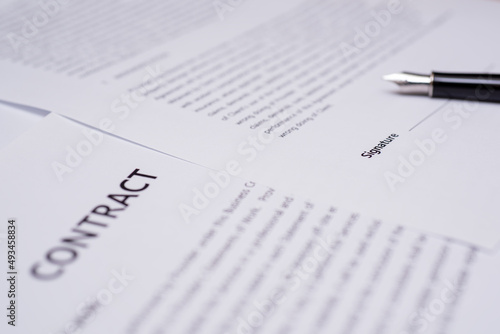 Close up of hand writing on contract 