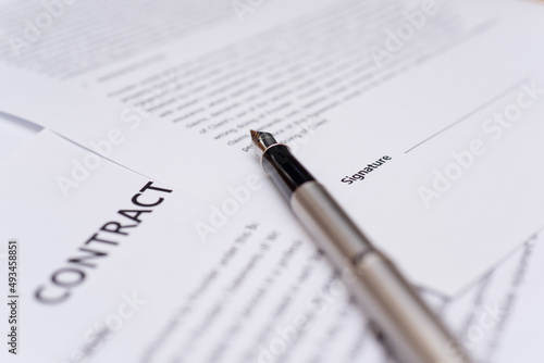 Close up of hand writing on contract 