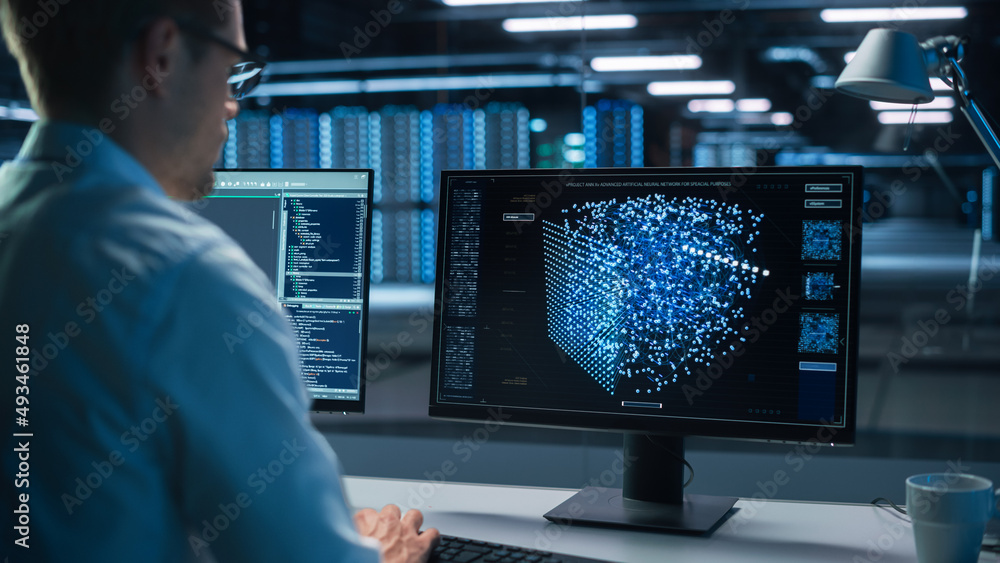 Technical Operator Works at His Workstation with Display Showing Neural Network In the System Control Room. IT Technician Works on Artificial Intelligence, Big Data Research Facility Technical Operator Works at His Workstation with Display Showing Neural Network In the System Control Room. IT Technician Works on Artificial Intelligence, Big Data Research Facility