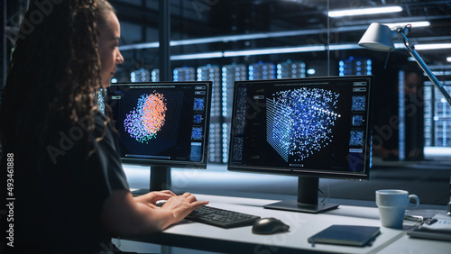 Smart Female IT Programer Working on Desktop Green Mock-up Screen Computer in Data Center System Control Room. Professional Programming Sophisticated Code in a High Tech Development Laboratory.