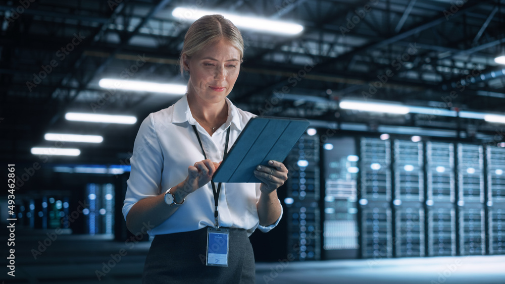 Data Center Female e-Business Entrepreneur Use Tablet Computer with Pleasure Smile. Information Technology Engineer and System Administrator work in Big Cloud Computing Server Farm. Data Center Female e-Business Entrepreneur Use Tablet Computer with Pleasure Smile. Information Technology Engineer and System Administrator work in Big Cloud Computing Server Farm.