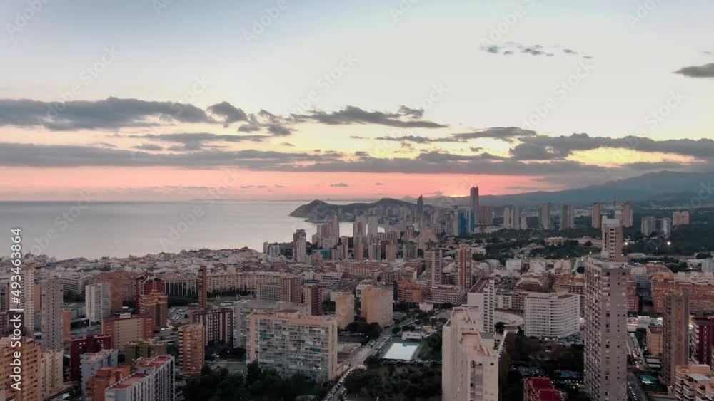 Establishing aerial view of Benidorm skyline skyscrapers, flying through hotels, Benidorm seaside coastline Spain Alicante at sunset Establishing aerial view of Benidorm skyline skyscrapers, flying through hotels, Benidorm seaside coastline Spain Alicante at sunset