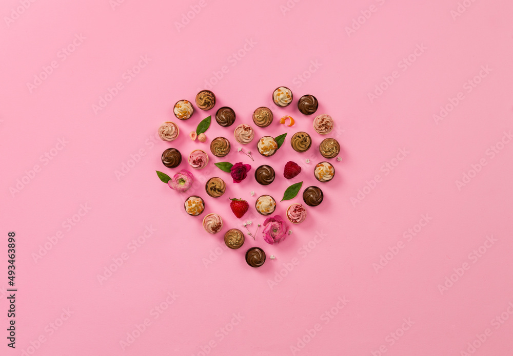 heart made of chocolates on pink background heart made of chocolates on pink background