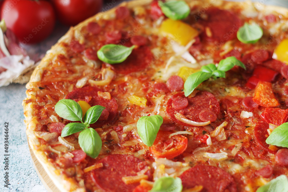 Pizza with salami and basil Pizza with salami and basil