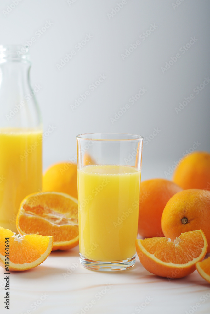 Oranges and orange juice in glasses Oranges and orange juice in glasses