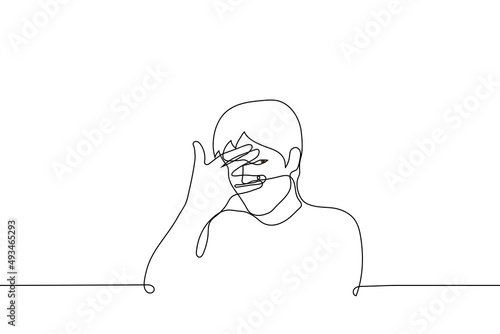 man covers face with palm but spreads fingers and peeps - one line drawing vector. concept of guilty pleasure, unwillingness to look, close one's own eyes