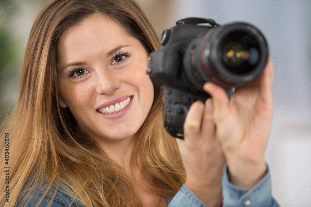 attractive female photographer holding camera attractive female photographer holding camera