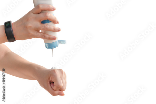 Woman pouring sun protection cream on her hand isolated in clipping path.