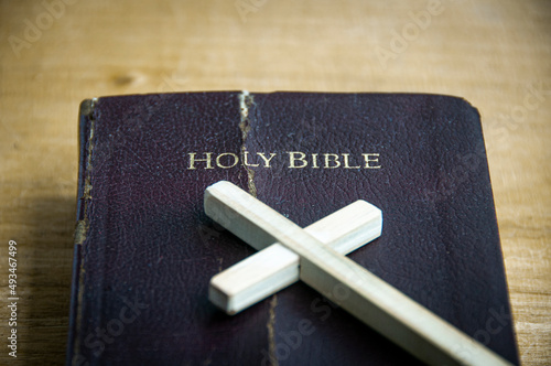 Top view of Holy Bible with wooden cross. Christianity and religious concept photo