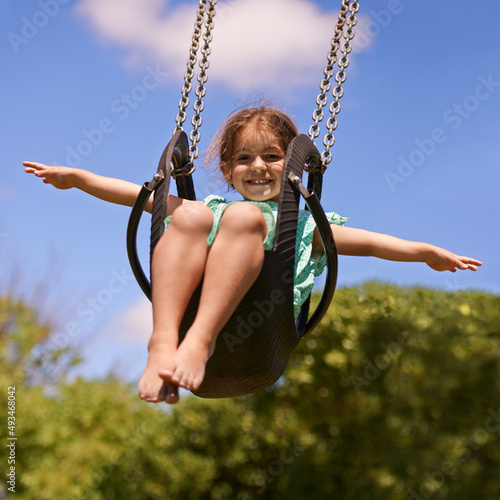 Nothing better than a swing. Shot of a young girl playing on a swing outsdie.