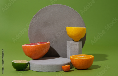 set of citrus fruits on concrete shapes with copy space