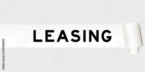 Ripped gray paper background that have word leasing under torn part