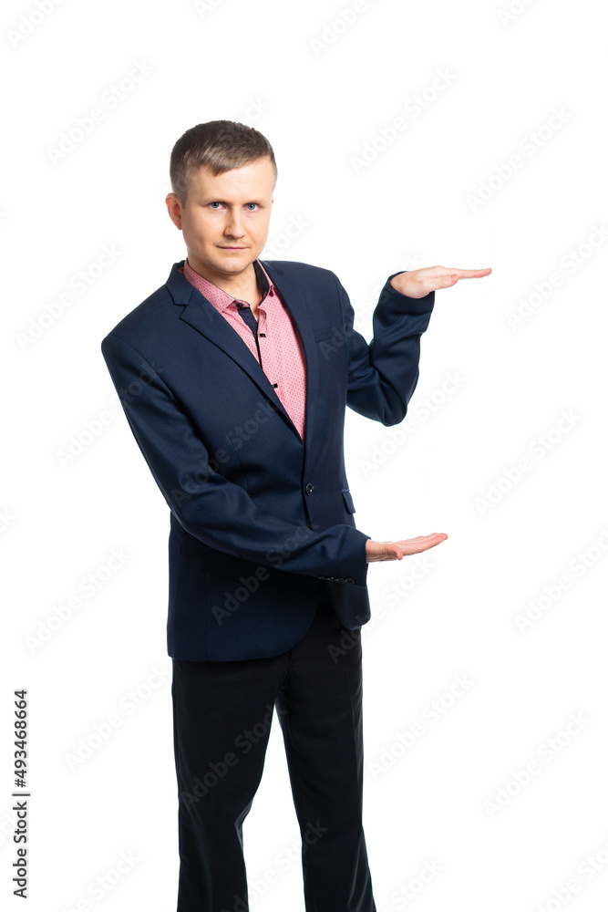a young man in a business suit holds his hands horizontally, parallel to his hand to his hand. place for writing, place for the subject. isolated a young man in a business suit holds his hands horizontally, parallel to his hand to his hand. place for writing, place for the subject. isolated