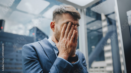 Vászonkép Stressed Out Manager Going Down from Office in a Glass Elevator in Modern Business Center