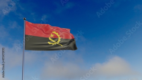 flag of Angola in the wind against the blue sky.