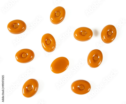 Tableau sur toile milk caramel candies isolated on white background