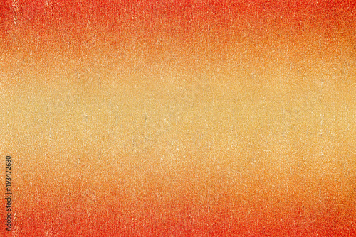 Texture of metallic crepe paper colored in red, orange and gold gradient