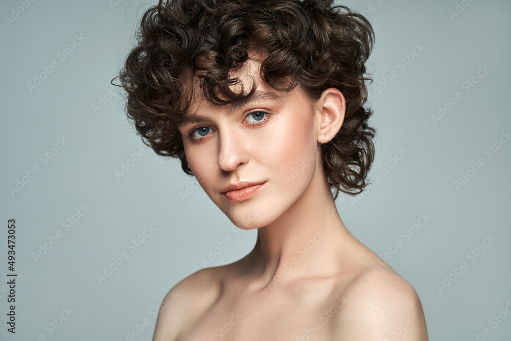 Close-up face of young woman with short curls and fresh skin Close-up face of young woman with short curls and fresh skin
