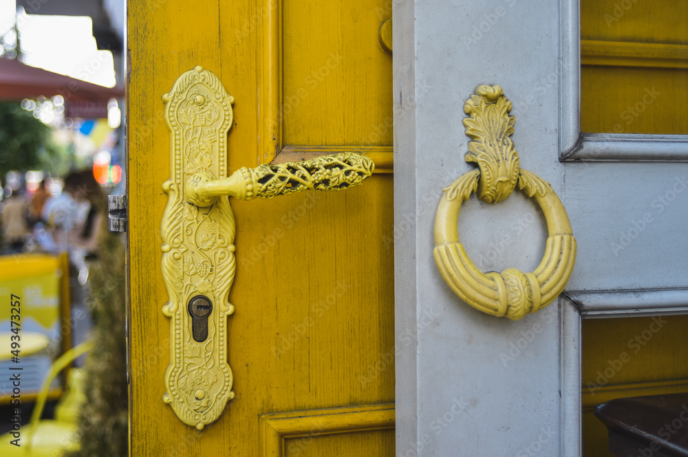 two antique yellow doorknobs on the doors two antique yellow doorknobs on the doors