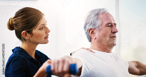 Regular exercise is vital as you grow older. Shot of an attractive young female physiotherapist working with a senior male patient.