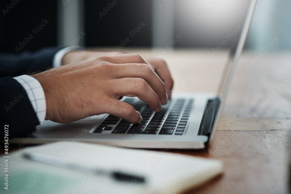 Technology helps him take charge of business. Closeup shot of an unrecognizable businessman working on a laptop in an office. Technology helps him take charge of business. Closeup shot of an unrecognizable businessman working on a laptop in an office.