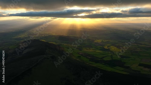 Mount Leinster, Carlow, Ireland, March 2022. Drone pulls northeast across Rathnageeragh hill at a high altitude facing southwest towards Borris and Ballymurphy with Kilkenny in the distance at sunset. photo