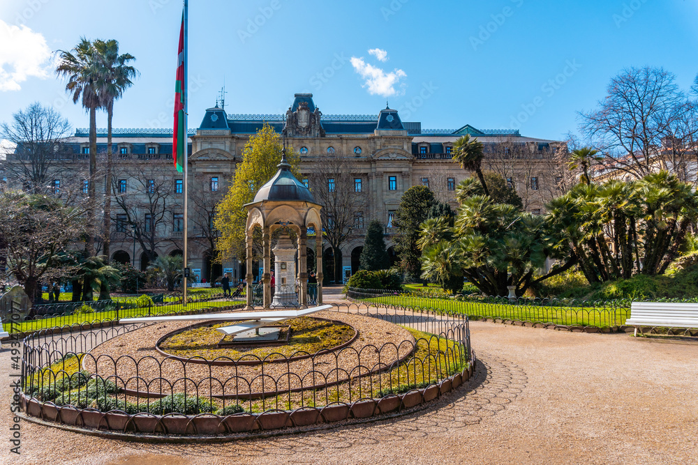 Fototapeta premium Gardens and clock of the Plaza Gipuzkoa in the center of San Sebastian, tourist city a spring morning. Gipuzkoa, Basque Country