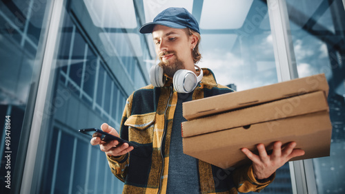 Foto Young Food Delivery Person Riding Glass Elevator in Modern Office Building