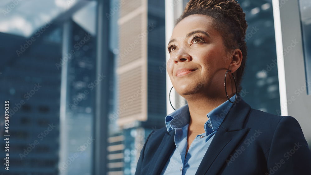 Portrait of Successful Black Businesswoman Riding Glass Elevator to Office in Modern Business