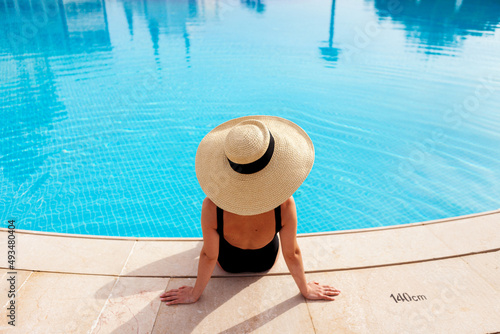 Beautiful woman sunbathing by the pool top view horizontal. Summer background. Poster, mock up for design