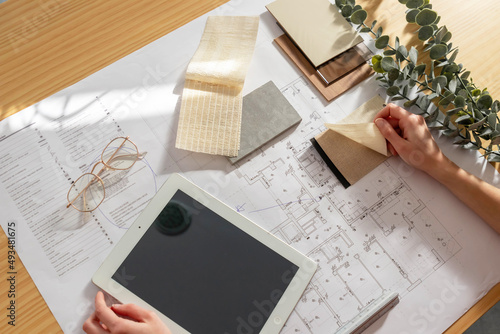 Top view of interior designer hands working on sample choosing while on table