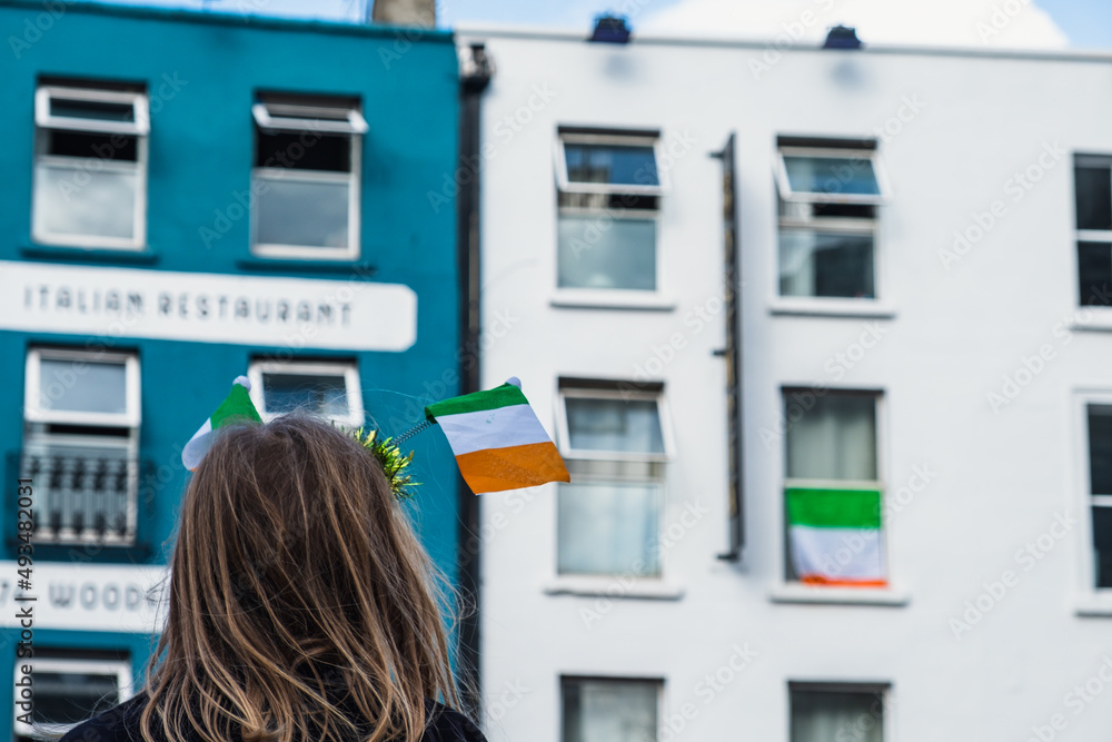 Irish flag between held by a girl, Saint Patrick day parade in Dublin, 2022